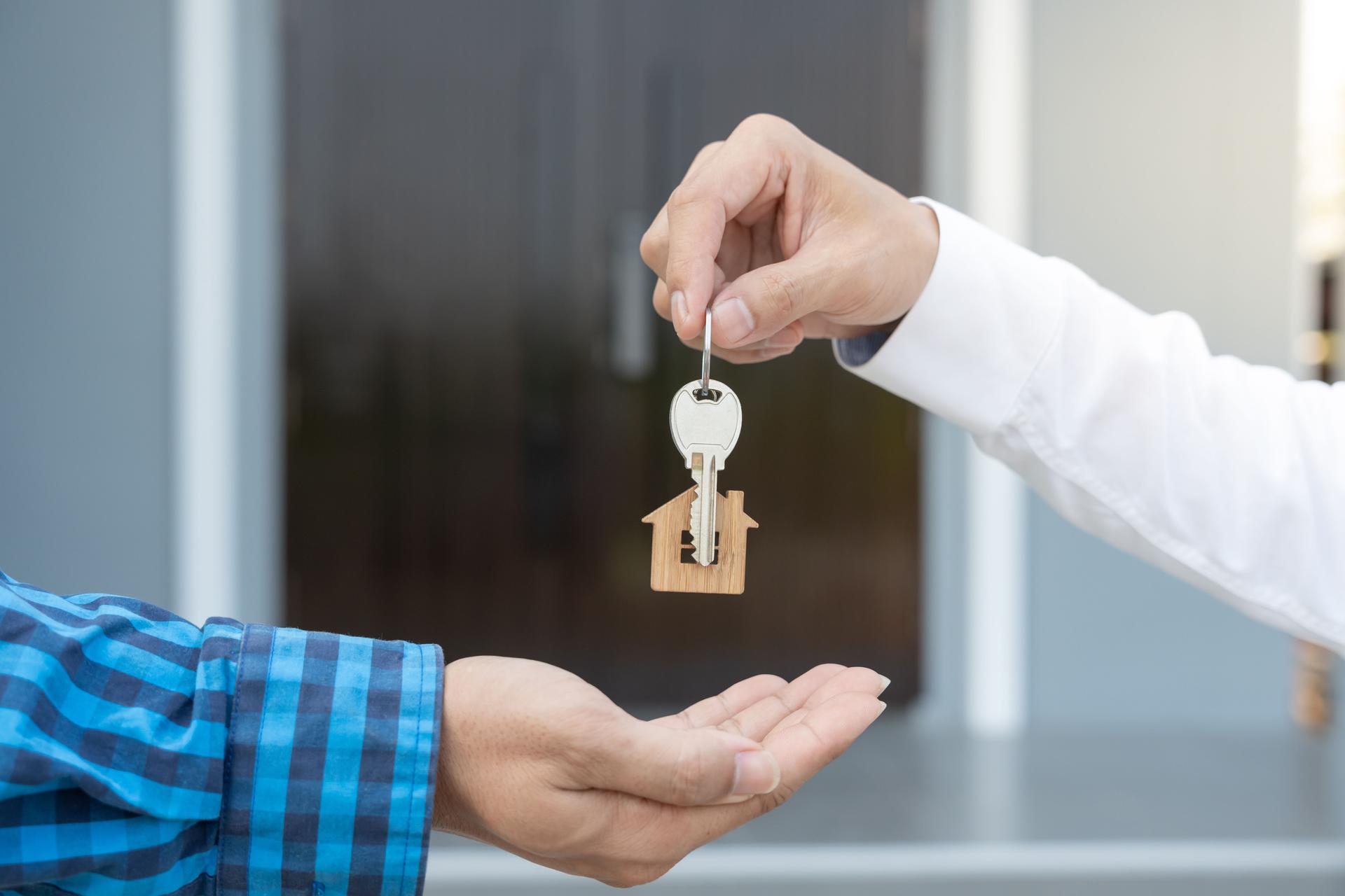 lease, rental and selling home. Real estate agent manager smile holding key for new owner.  rent house, Sales, loan credit financial, insurance, Seller, dealer, installment,  buy, sell, move in